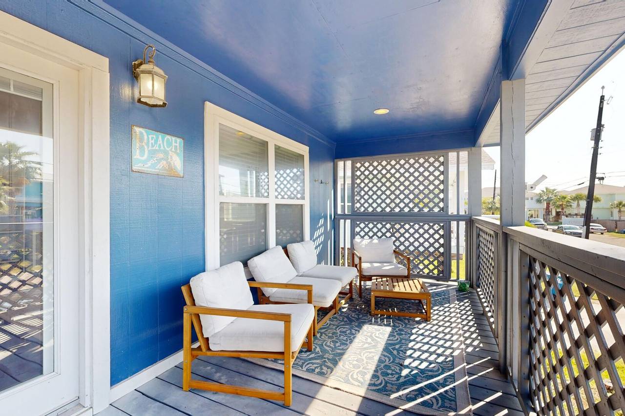 Covered balcony with seating overlooking the street