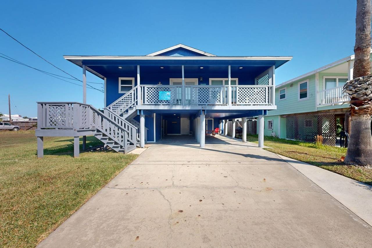 Exterior of The Farley Beach House, a blue stilt home in Port Aransas